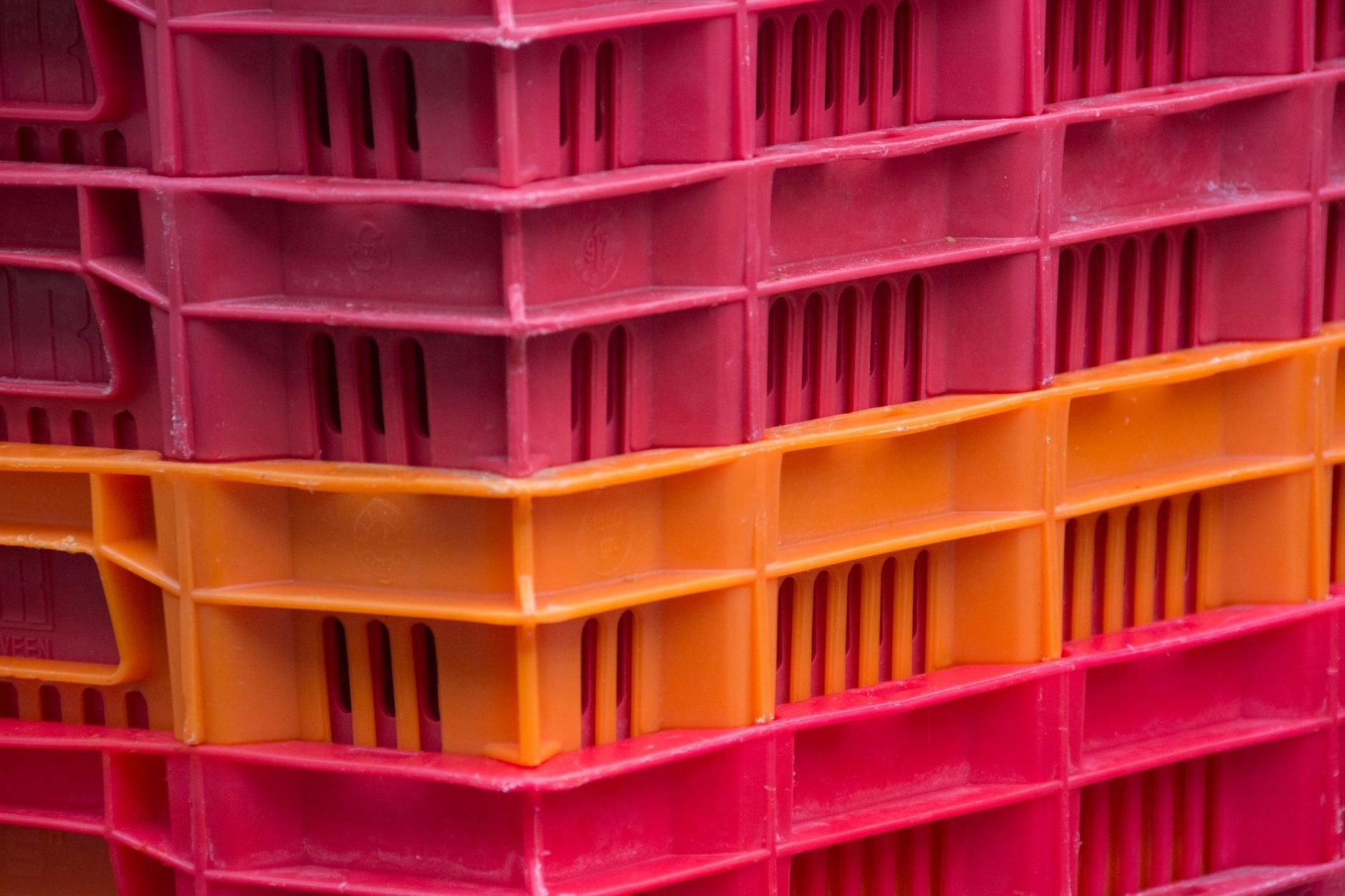 Close-up of stacked plastic egg crates in a warehouse